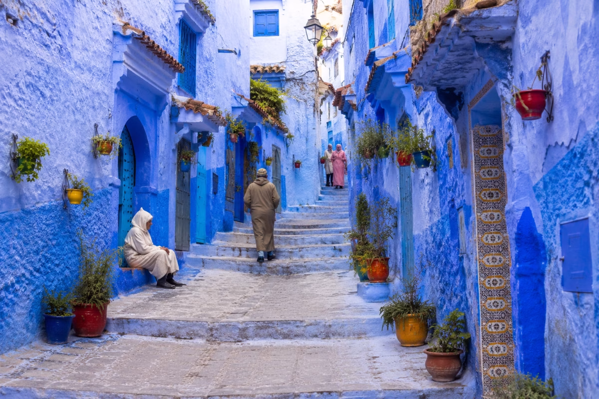 Authentic Chefchaouen blue medina with narrow streets, traditional doors and local activity